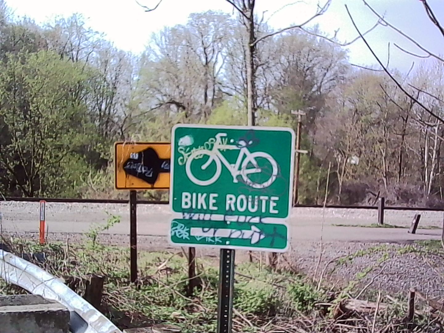 A tagged up sign for the bike trail
